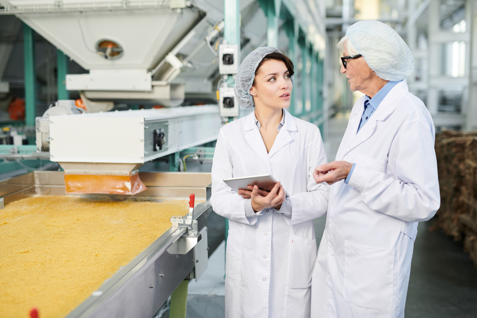 Two Female Workers Overseeing Food Production