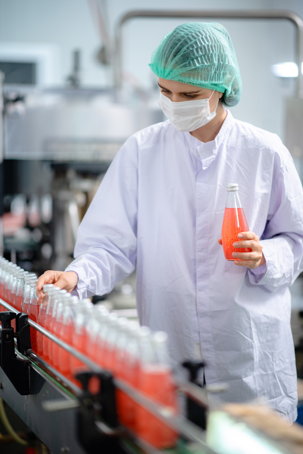 Food Technician Control Checking Production Line of Water Drink in Manufacturing Factory